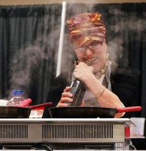 A man holding a sword in front of an oven.