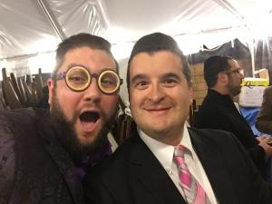 Two men in suits and ties posing for a picture.