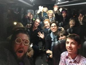 A group of people standing in the back of a bus.