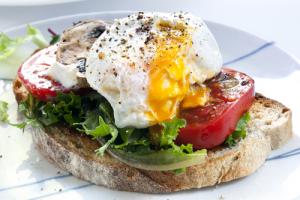 A sandwich with an egg on top of it.