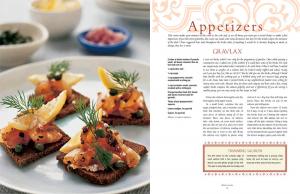 A cookbook with food on it and the pages of the book.