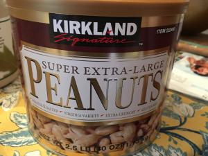 A jar of peanuts sitting on top of a table.