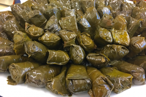 A pile of stuffed grape leaves on top of a table.