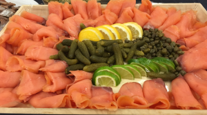 A platter of food with lemon, lime and other ingredients.