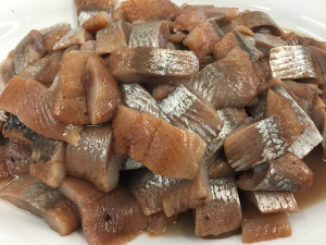 A pile of meat on top of a white plate.
