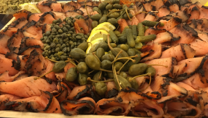 A plate of food with pickles and other foods.