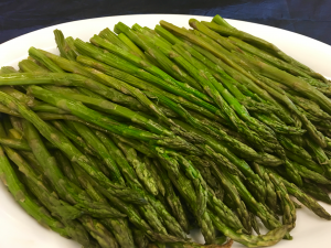A plate of asparagus on the table.
