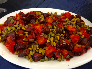 Beet and pistachio salad on white platter