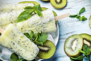 A plate of food with kiwi and ice cream.