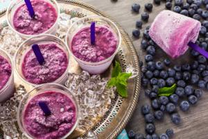 A tray of frozen yogurt with blueberries on top.