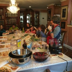 A group of people sitting around a table with food.