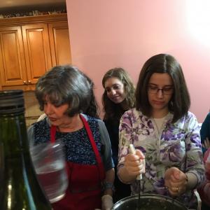 A group of people standing around in a room.