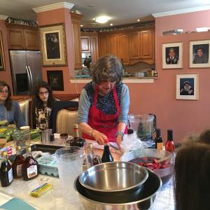 A woman in an apron is cooking food.