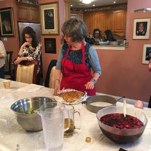 A woman in an apron is preparing food.