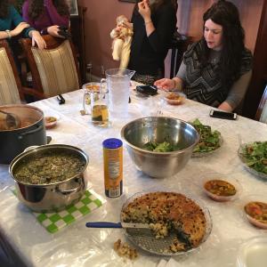 A group of people sitting around a table with food.