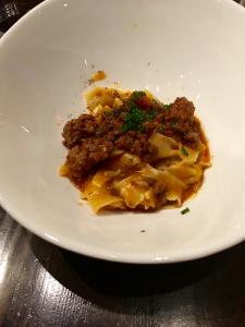 A white bowl with some food on top of it