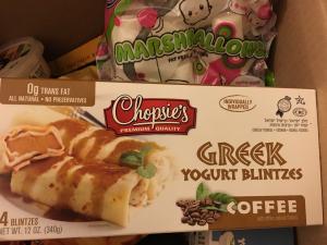 A box of greek yogurt blintz with coffee.