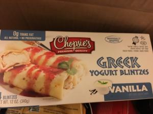 A box of frozen yogurt burrito with sauce.