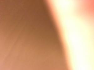 A blurry image of the sun shining on a beach.