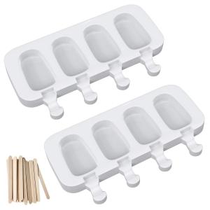 Two ice popsicle molds with sticks in them.
