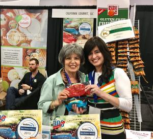 Two women posing for a picture at an event.