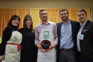Group of five smiling, man holding award plate