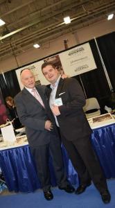 Two men in suits posing for a picture.