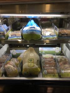 A display case filled with lots of different types of food.