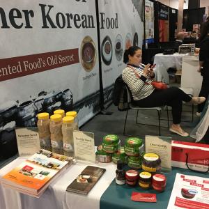 Korean food booth with condiments and visitor