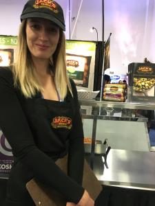 A woman standing in front of an oven.