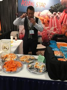A woman standing in front of a table with food.