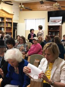 A group of people sitting in chairs at a library.
