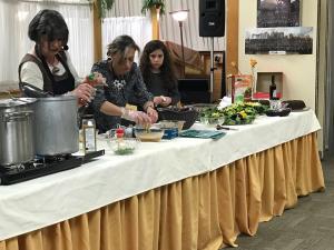 A group of people sitting at a table preparing food.