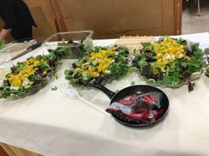 A table with several trays of flowers on it.