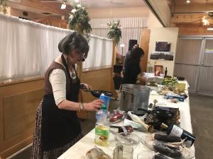 A woman in a kitchen preparing food.