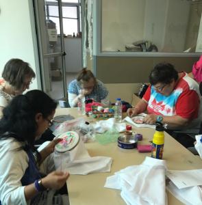 A group of people sitting at a table with papers.