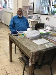 Man at workshop table with craft molds