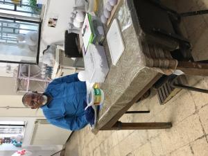 A man sitting at a table with papers on it.