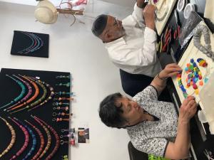 Two people sitting at a table with papers on it.