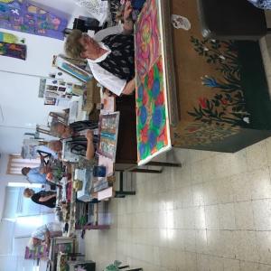 Seniors painting at community art workshop