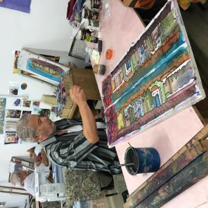 A person sitting at a table with a large board game.