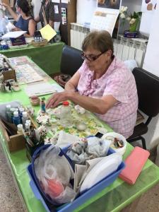 A woman sitting at a table with papers on it.