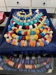 Colorful disc bead necklaces on blue tray