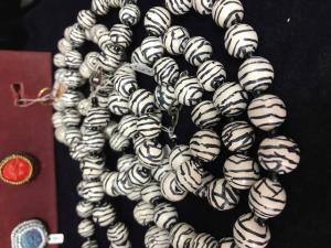 A large black and white bead necklace.