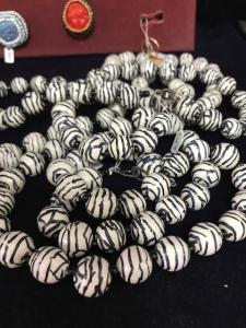 A close up of a necklace with black and white beads