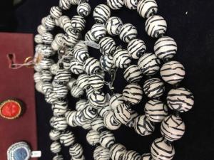 A large necklace of zebra beads is displayed.