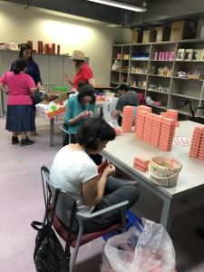 A group of people sitting at tables in a library.