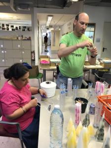 A man and woman working in a room.