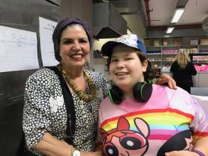 A woman and girl with headphones on.