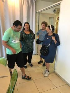 A group of people standing around in a room.